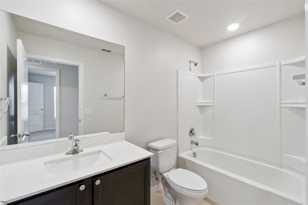 1729 Canaan Loop Dundee, FL 33838 - Photo 23 of 33 a bathroom with a sink toilet tub and shower