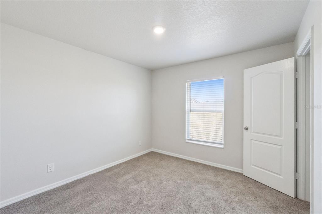 1729 Canaan Loop Dundee, FL 33838 - Photo 25 of 33 an empty room with windows and closet