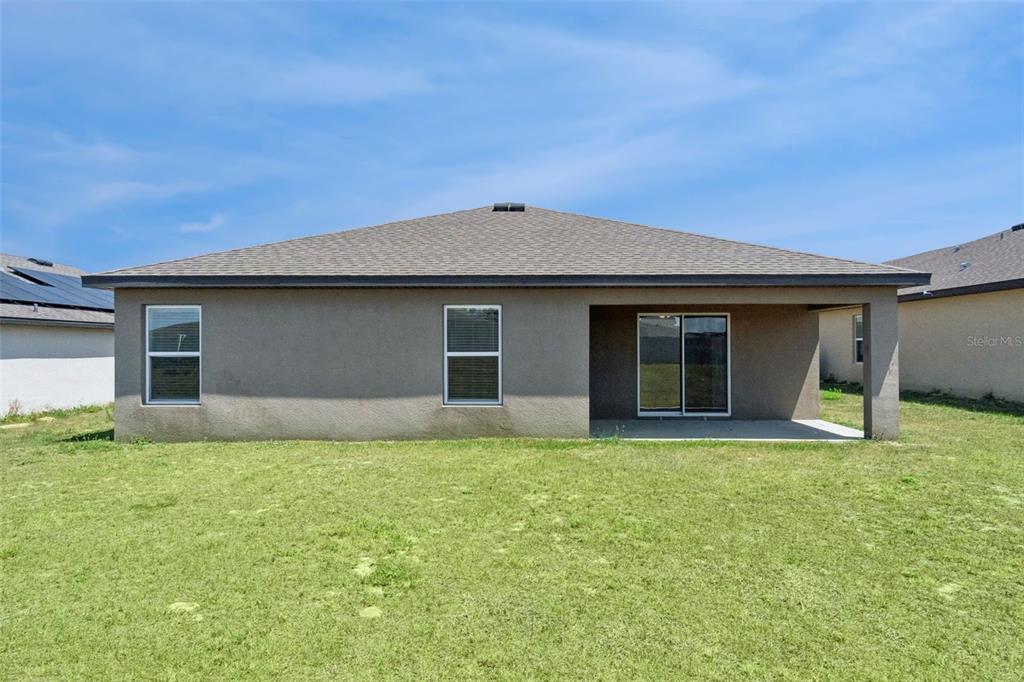 1729 Canaan Loop Dundee, FL 33838 - Photo 27 of 33 front view of house with a yard