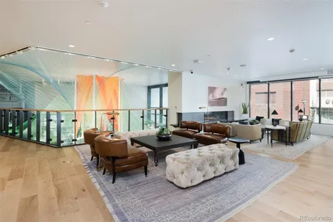 a view of a living room hardwood floor and a large window
