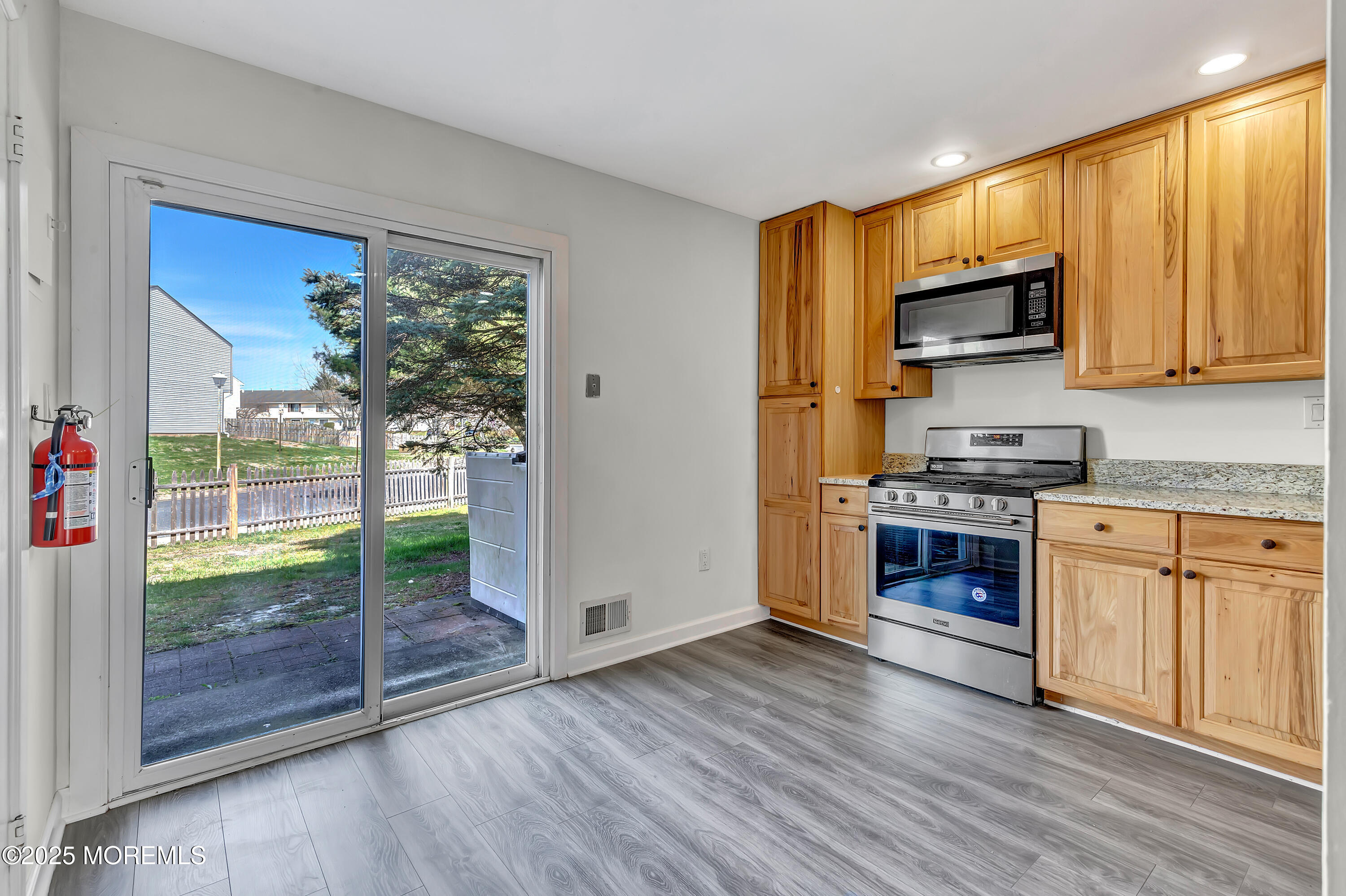 7 Creek Road Brick, NJ 08724 - Photo 11 of 26 a kitchen with stainless steel appliances granite countertop a refrigerator a stove top oven a sink and dishwasher with wooden floor