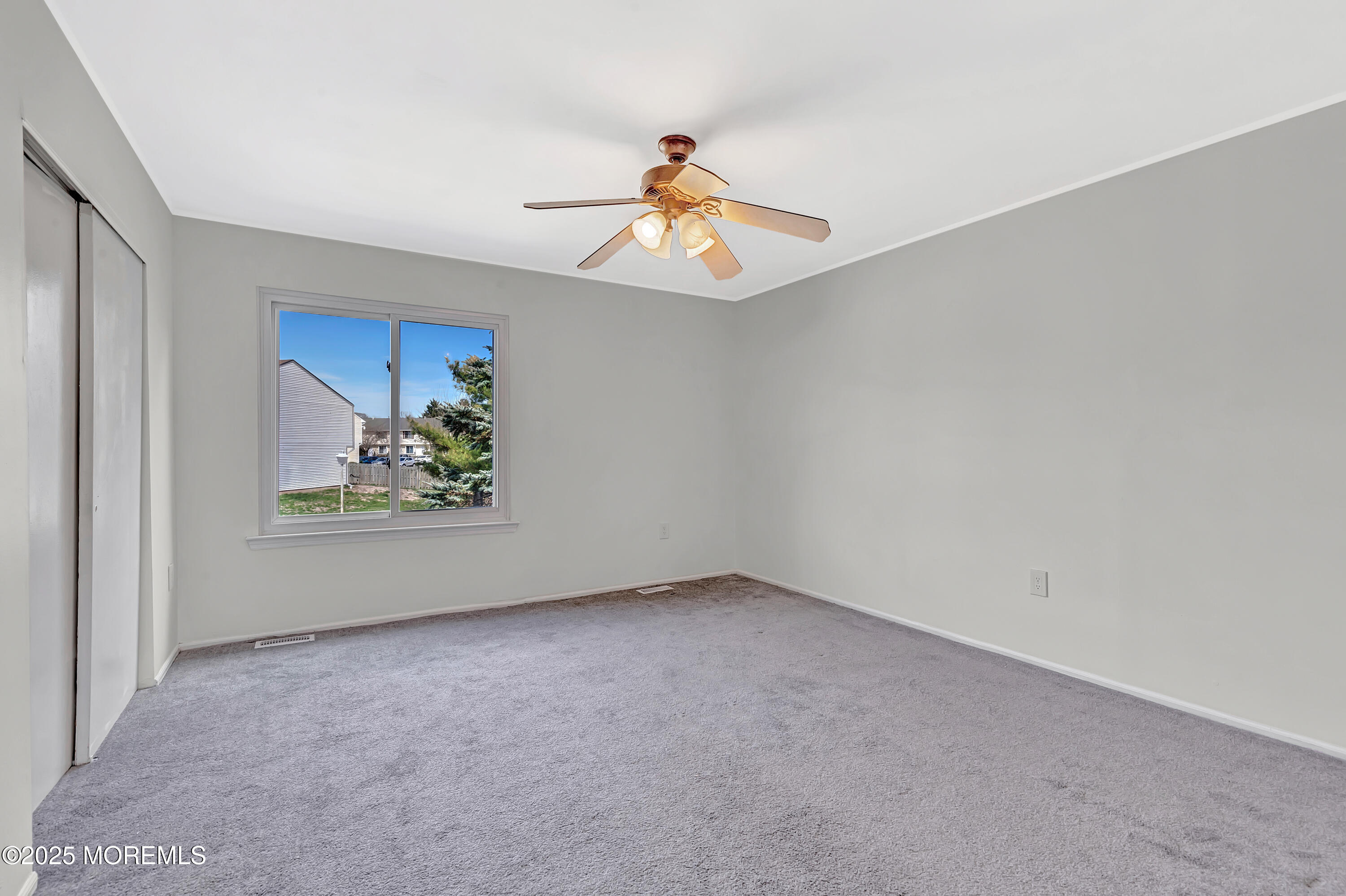 7 Creek Road Brick, NJ 08724 - Photo 21 of 26 an empty room with window and ceiling fan