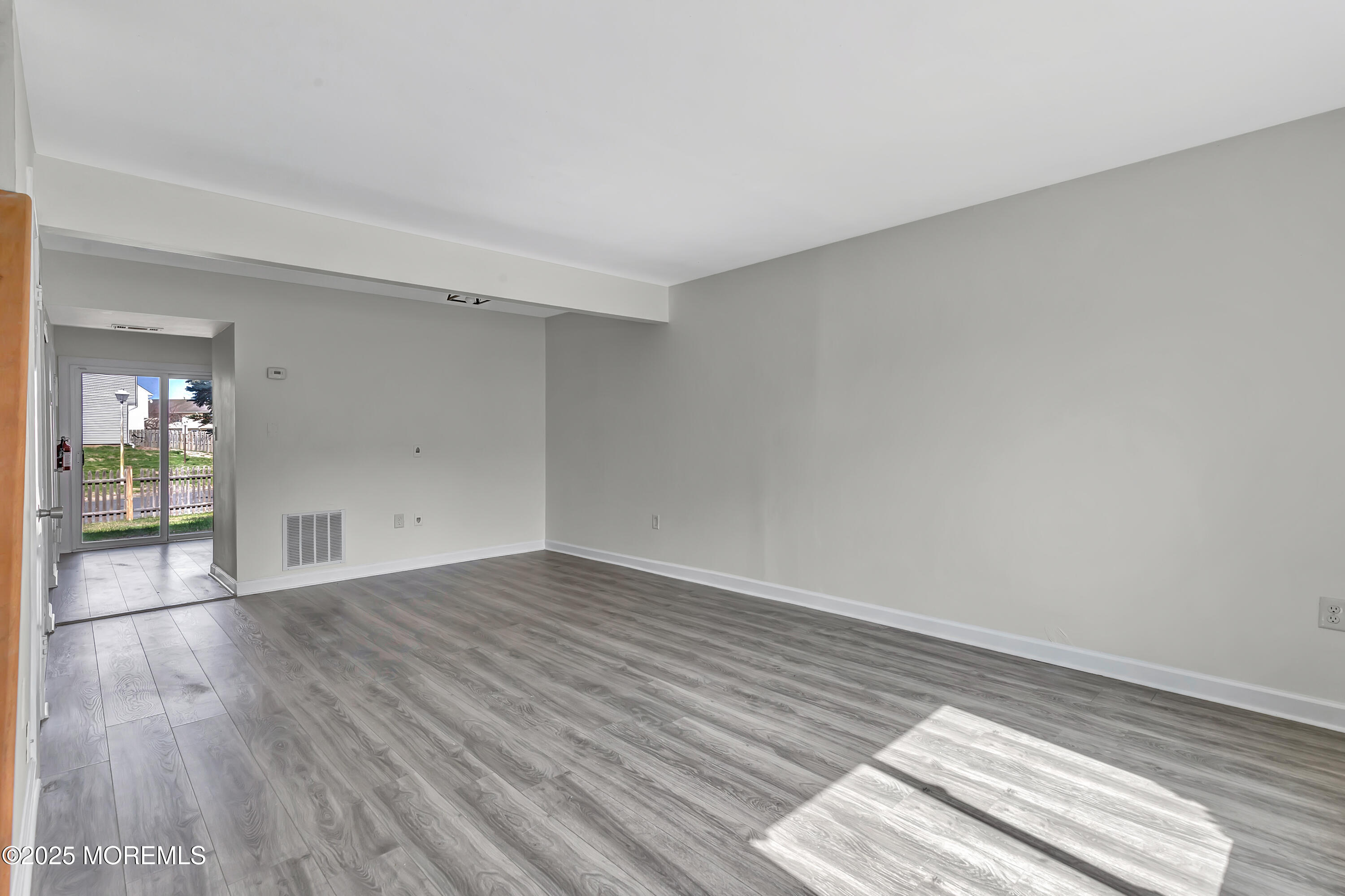 7 Creek Road Brick, NJ 08724 - Photo 6 of 26 a view of an empty room and wooden floor