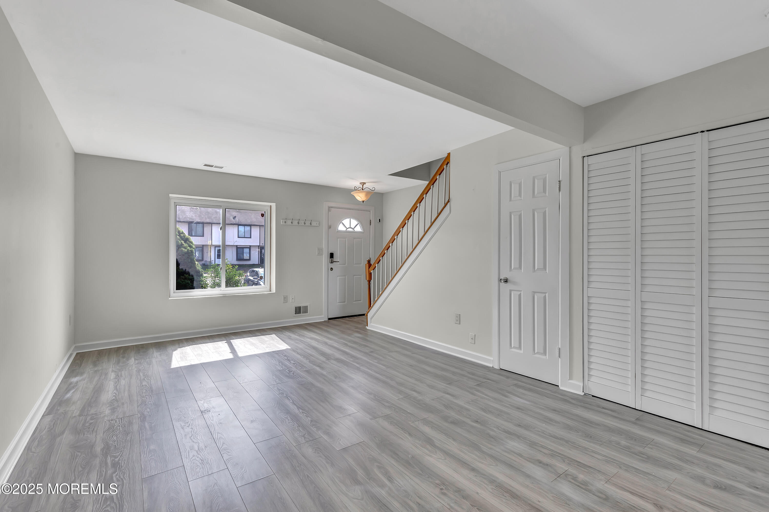 7 Creek Road Brick, NJ 08724 - Photo 9 of 26 a view of an empty room with wooden floor and a window