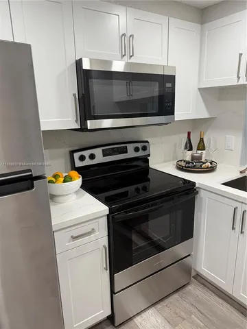 a kitchen with a stove and a microwave