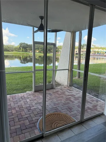 a view of a porch with a floor to ceiling window next to a yard