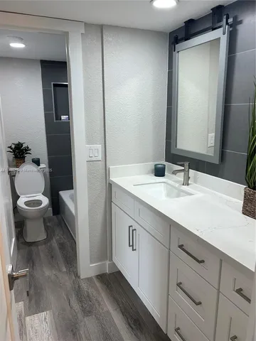 a bathroom with a double vanity sink and a toilet