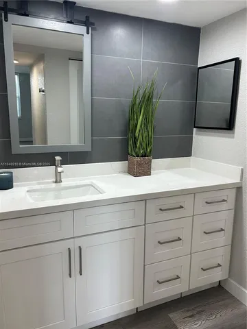 a bathroom with a sink and mirror