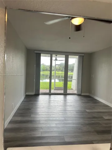 a view of room with window and wooden floor