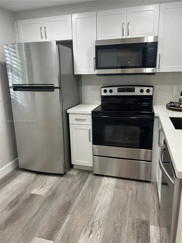 a kitchen with a stove and a refrigerator