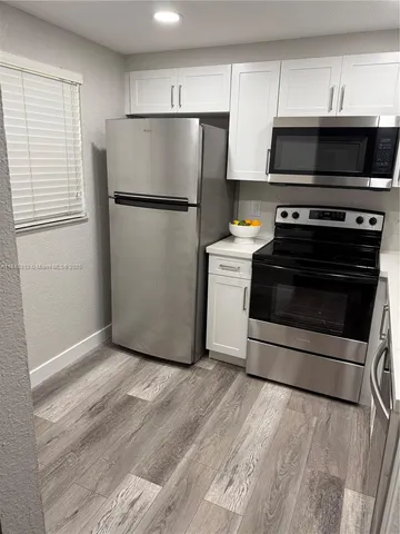 a kitchen with a stove and a refrigerator