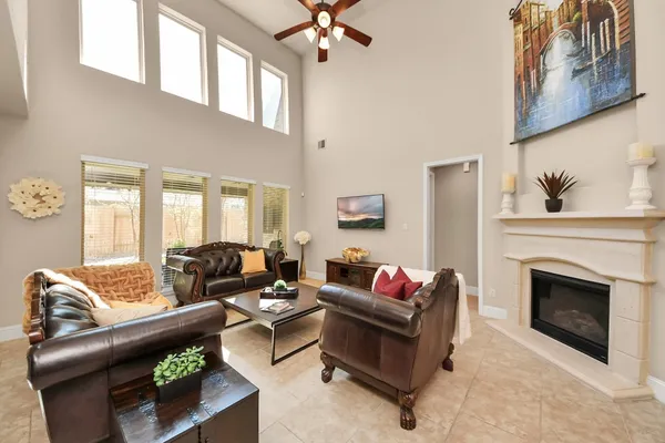 a living room with furniture fireplace and a window