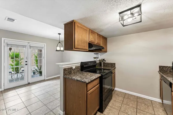 a kitchen with stainless steel appliances granite countertop a stove sink and cabinets