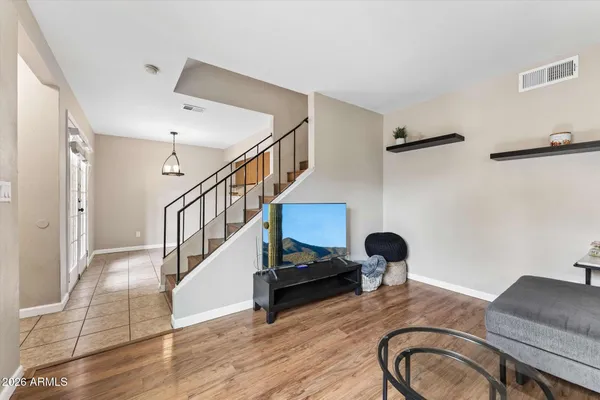 a view of entryway and hall with wooden floor