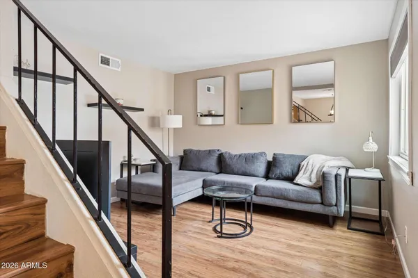 a living room with furniture and wooden floor