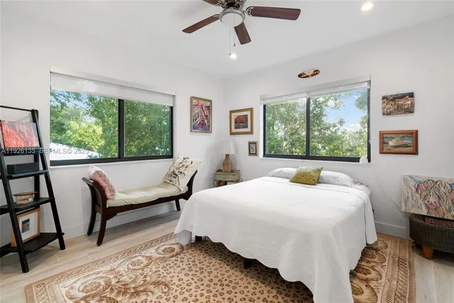 a bedroom with a bed a couch and a window