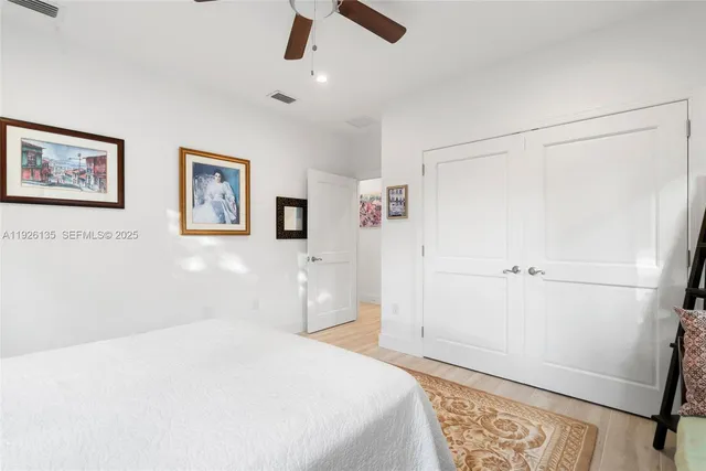 a bedroom with a large bed and a window