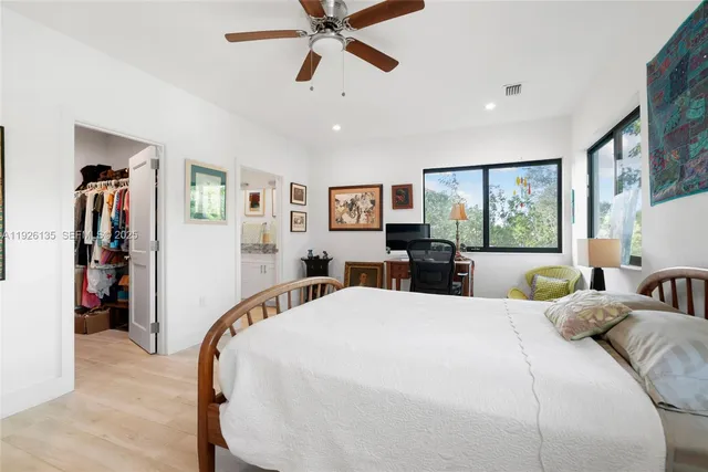 a bedroom with a large bed and a chandelier