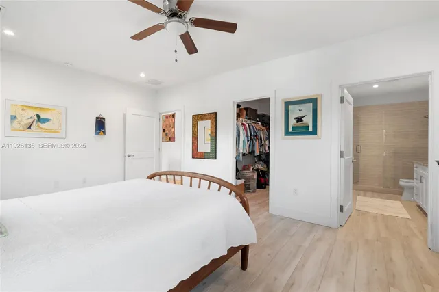 a bedroom with a large bed and a chandelier