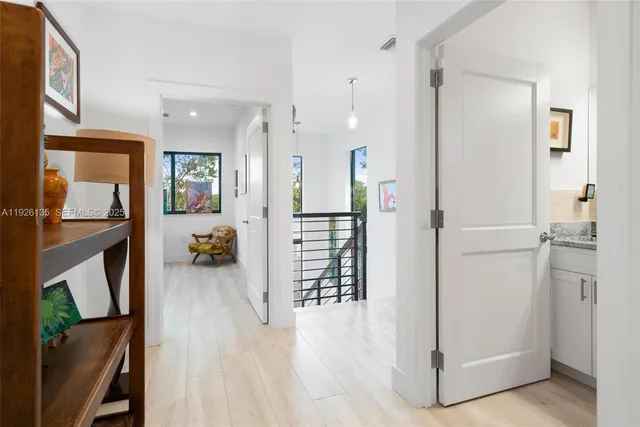 a view of a livingroom with furniture and a hallway
