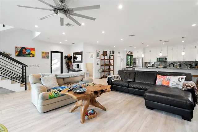 a living room with furniture and kitchen view