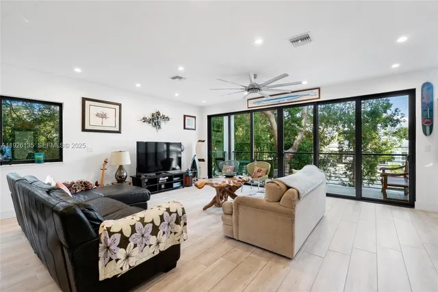 a living room with furniture and large windows