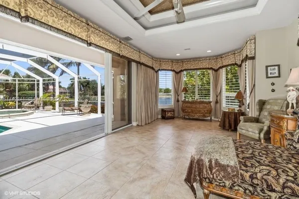 a living room with furniture and large windows