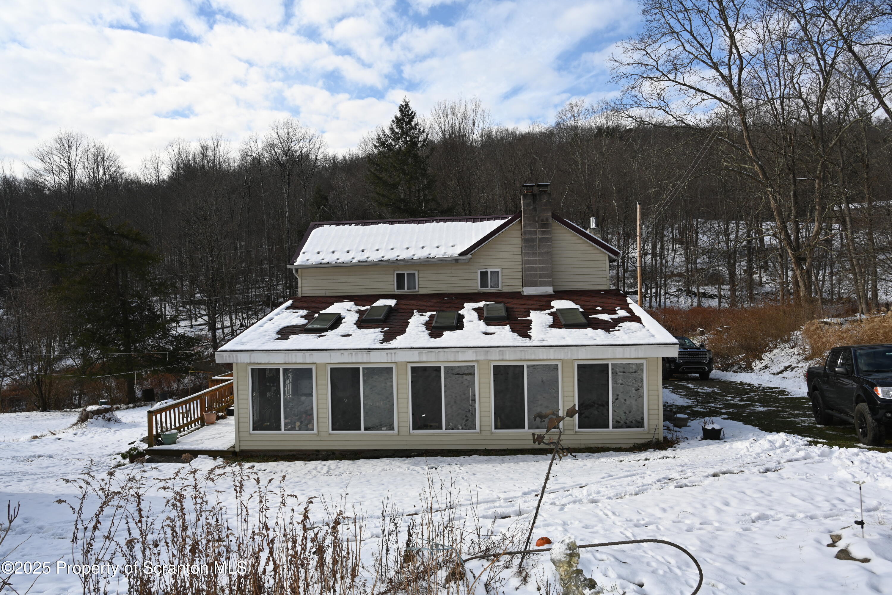 358 Barney Hollow Road Nicholson, PA 18446 - Photo 1 of 61 a front view of a house with a yard covered with snow in front of house