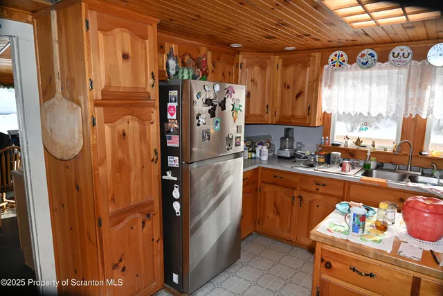 a kitchen with stainless steel appliances granite countertop a stove a sink dishwasher and cabinets with wooden floor