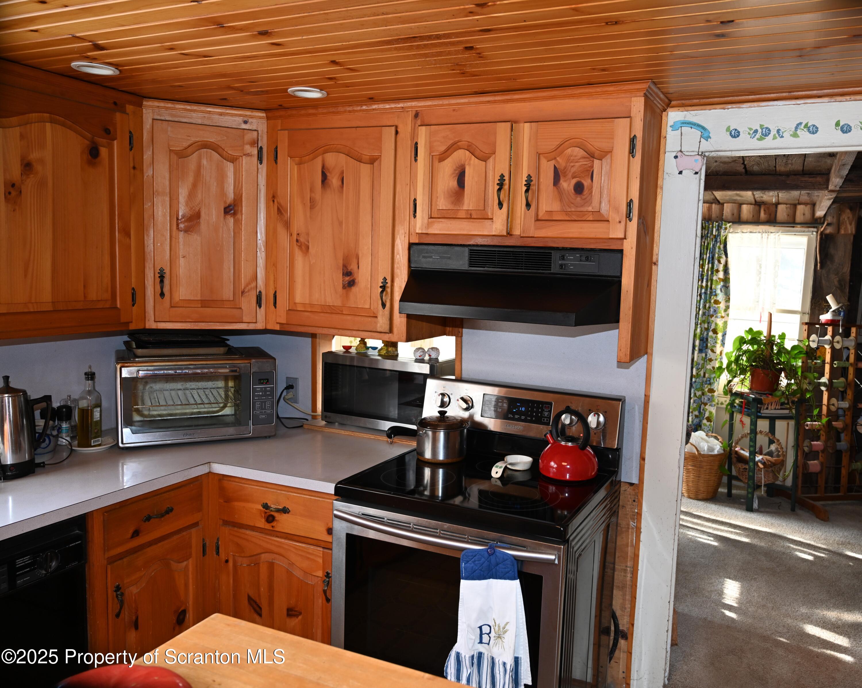 358 Barney Hollow Road Nicholson, PA 18446 - Photo 6 of 61 a kitchen with stainless steel appliances granite countertop a stove and a microwave