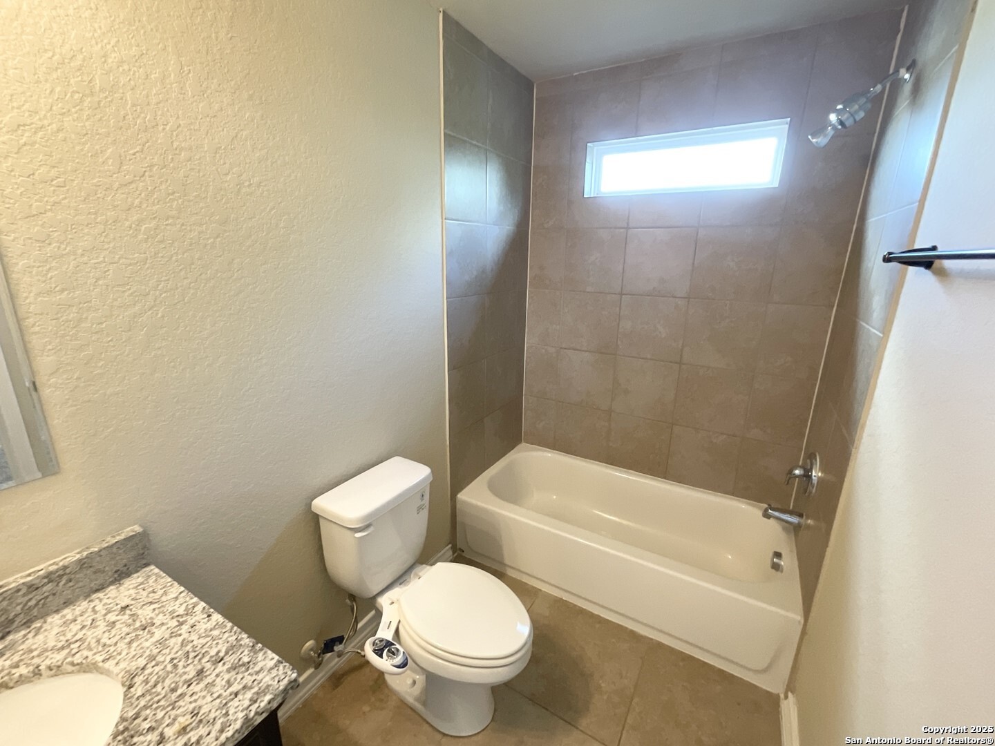 16820 Dancing Ava, Unit 2 Selma, TX 78154 - Photo 19 of 28 a white toilet sitting next to a bathroom sink and a tub