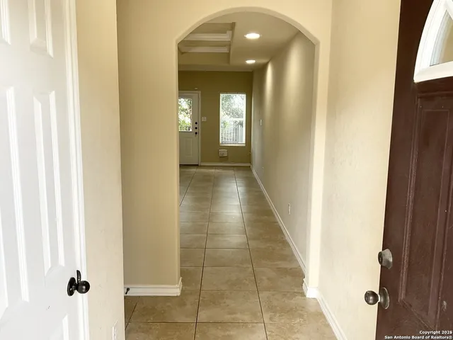 a view of a hallway with wooden floor