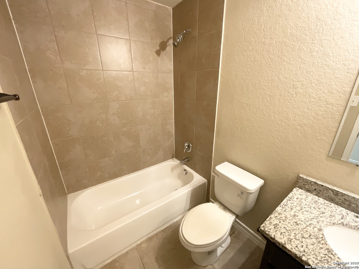 16820 Dancing Ava, Unit 2 Selma, TX 78154 - Photo 21 of 28 a white toilet and tub sitting next to a bathroom sink