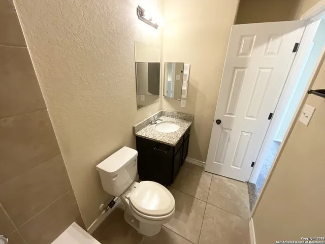 a view of an empty room with a mirror