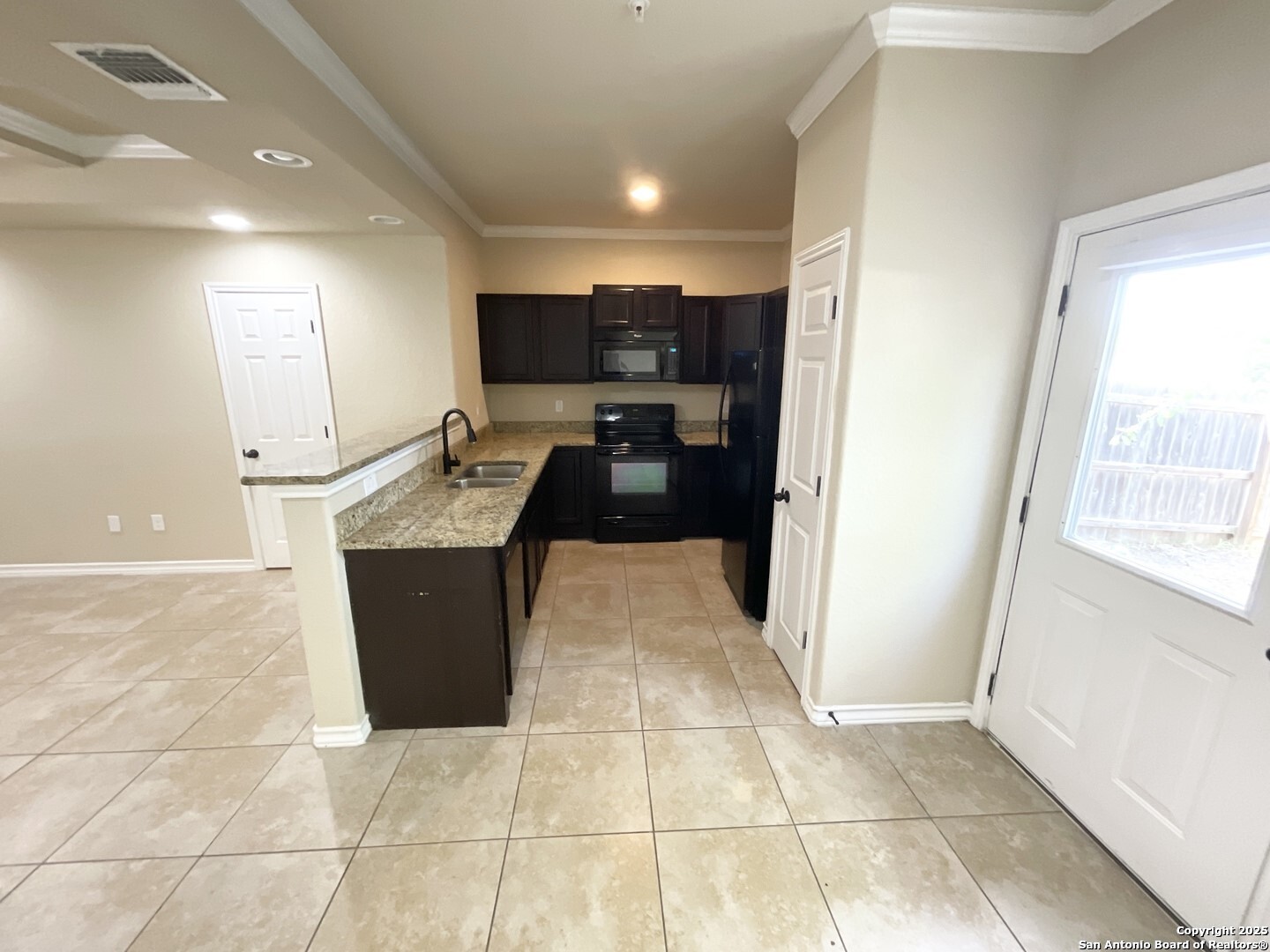 16820 Dancing Ava, Unit 2 Selma, TX 78154 - Photo 5 of 28 a kitchen with granite countertop a sink and a stove top oven