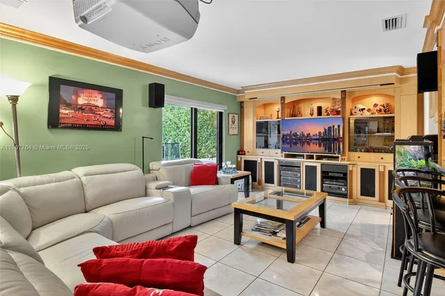 a living room with furniture a kitchen view and a fireplace