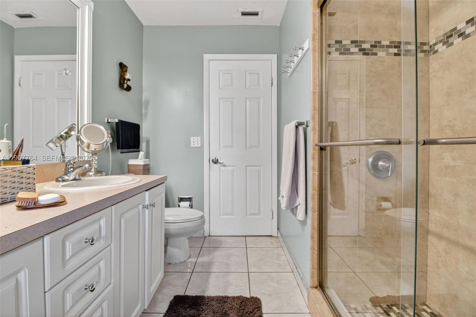 15010 Dunbarton Place Miami Lakes, FL 33016 - Photo 19 of 36 a bathroom with a double vanity sink toilet and shower