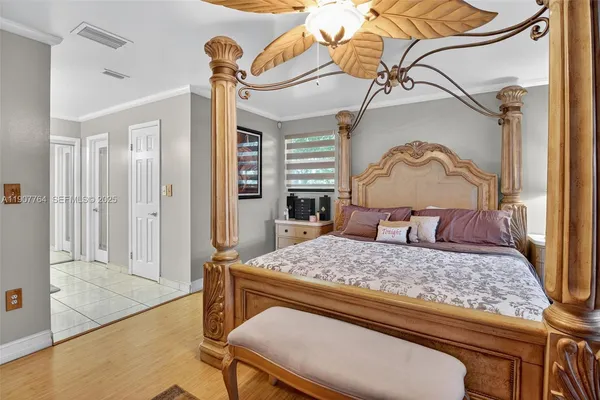 a bedroom with a bed and a chandelier