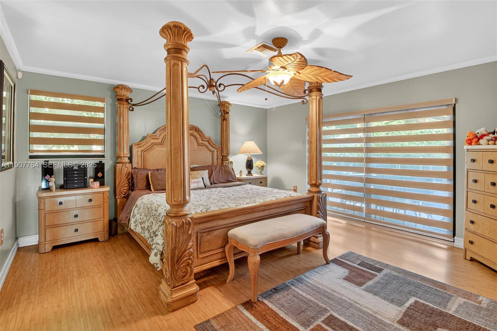 15010 Dunbarton Place Miami Lakes, FL 33016 - Photo 21 of 36 a bedroom with a bed and a chandelier