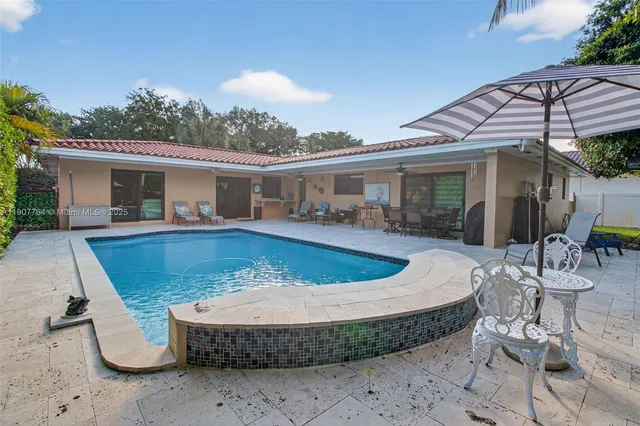 a view of a chairs and table in the patio