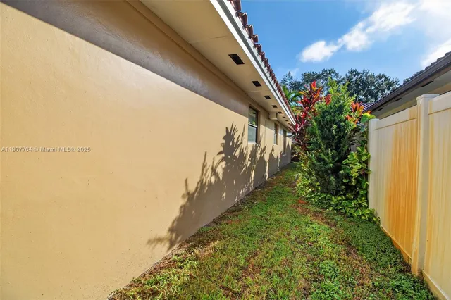 a view of a house with a flower garden