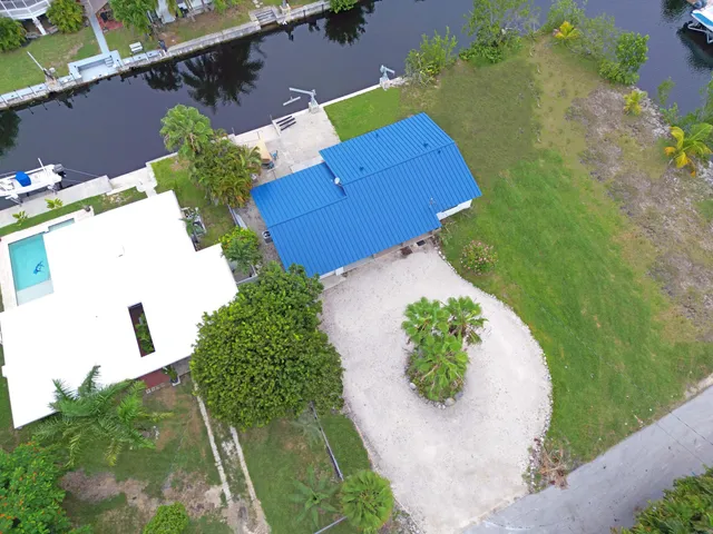 an aerial view of a house with a yard and a garage