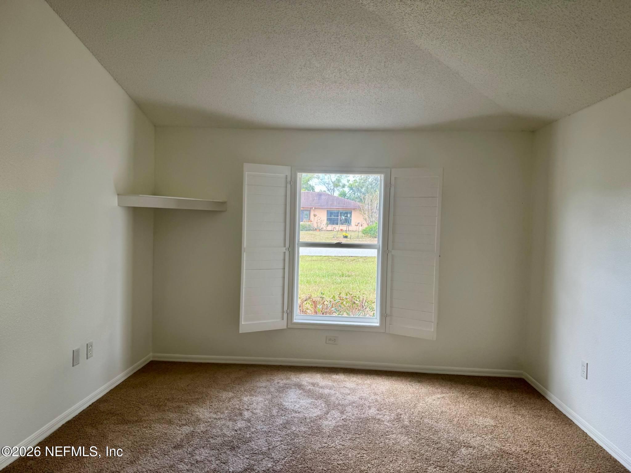 11447 Exmore Street Spring Hill, FL 34609 - Photo 12 of 31 an empty room with windows