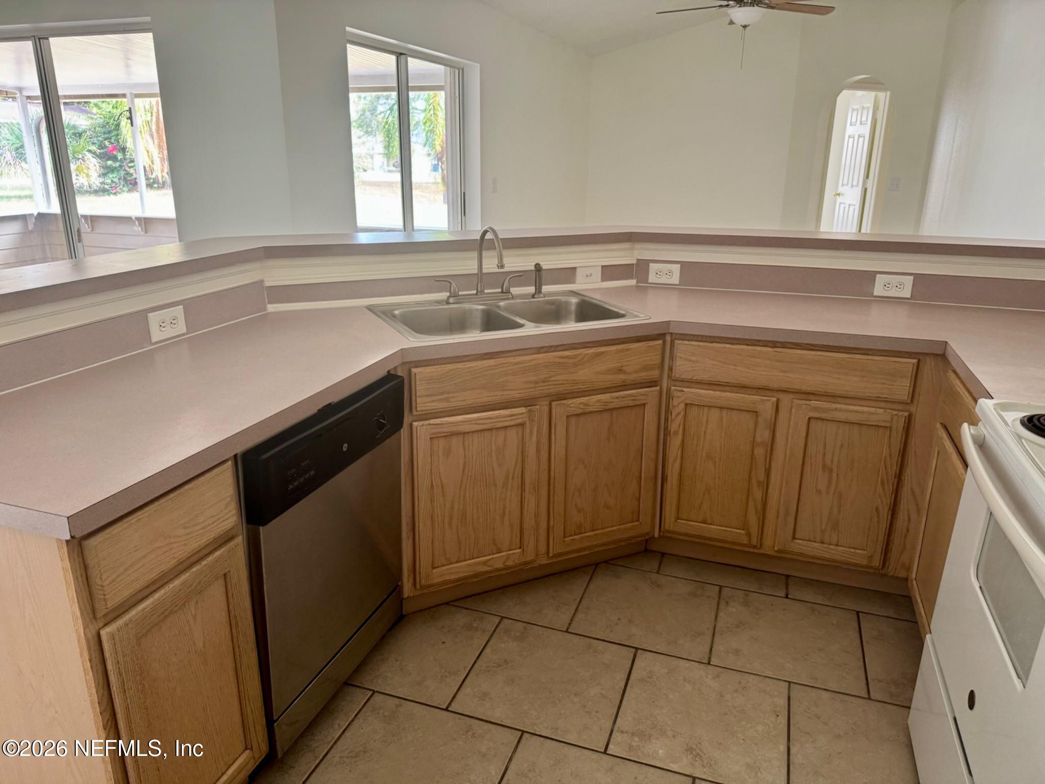 11447 Exmore Street Spring Hill, FL 34609 - Photo 18 of 31 a kitchen with a sink cabinets and window