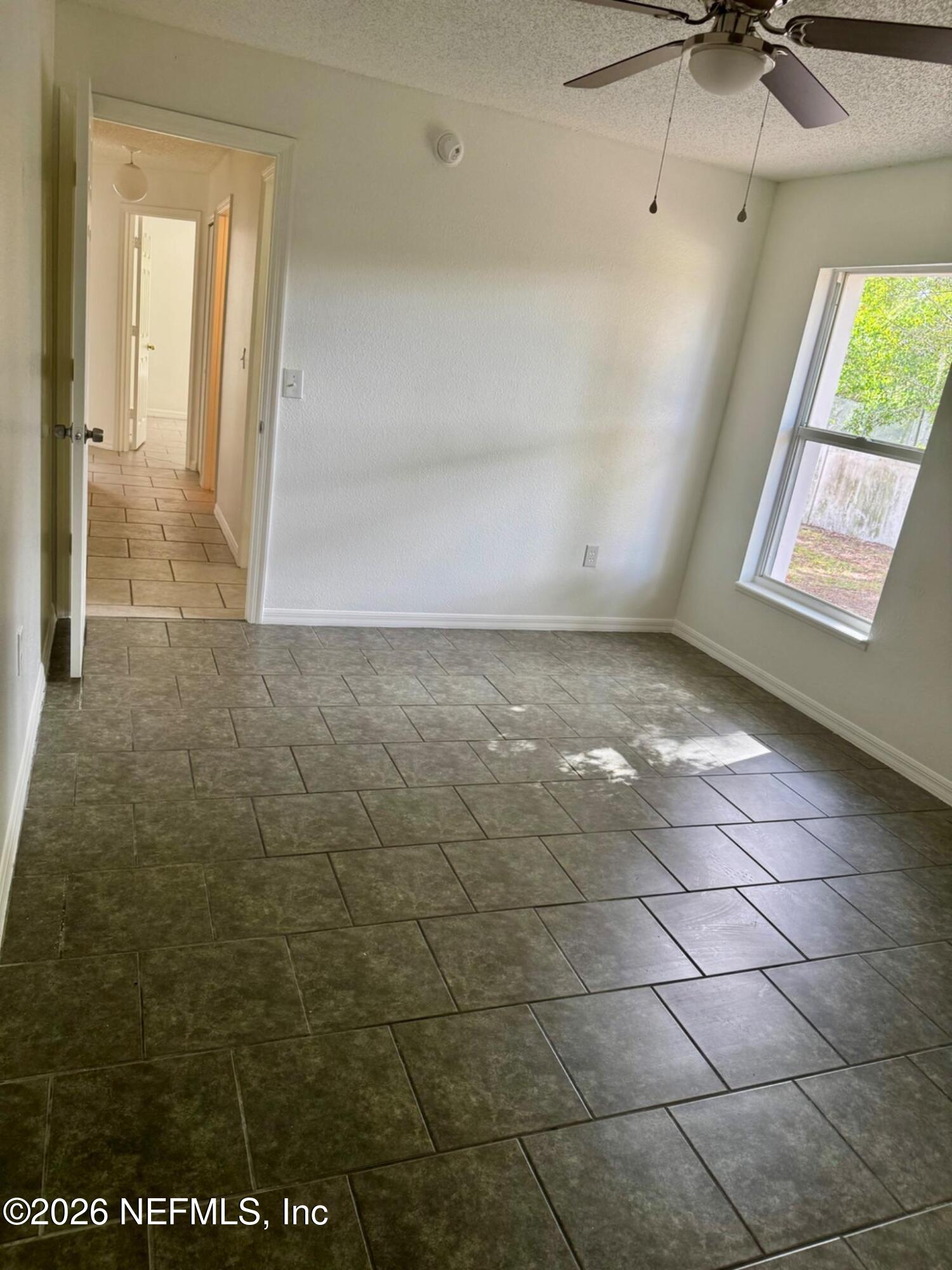 11447 Exmore Street Spring Hill, FL 34609 - Photo 23 of 31 a view of an empty room with a window