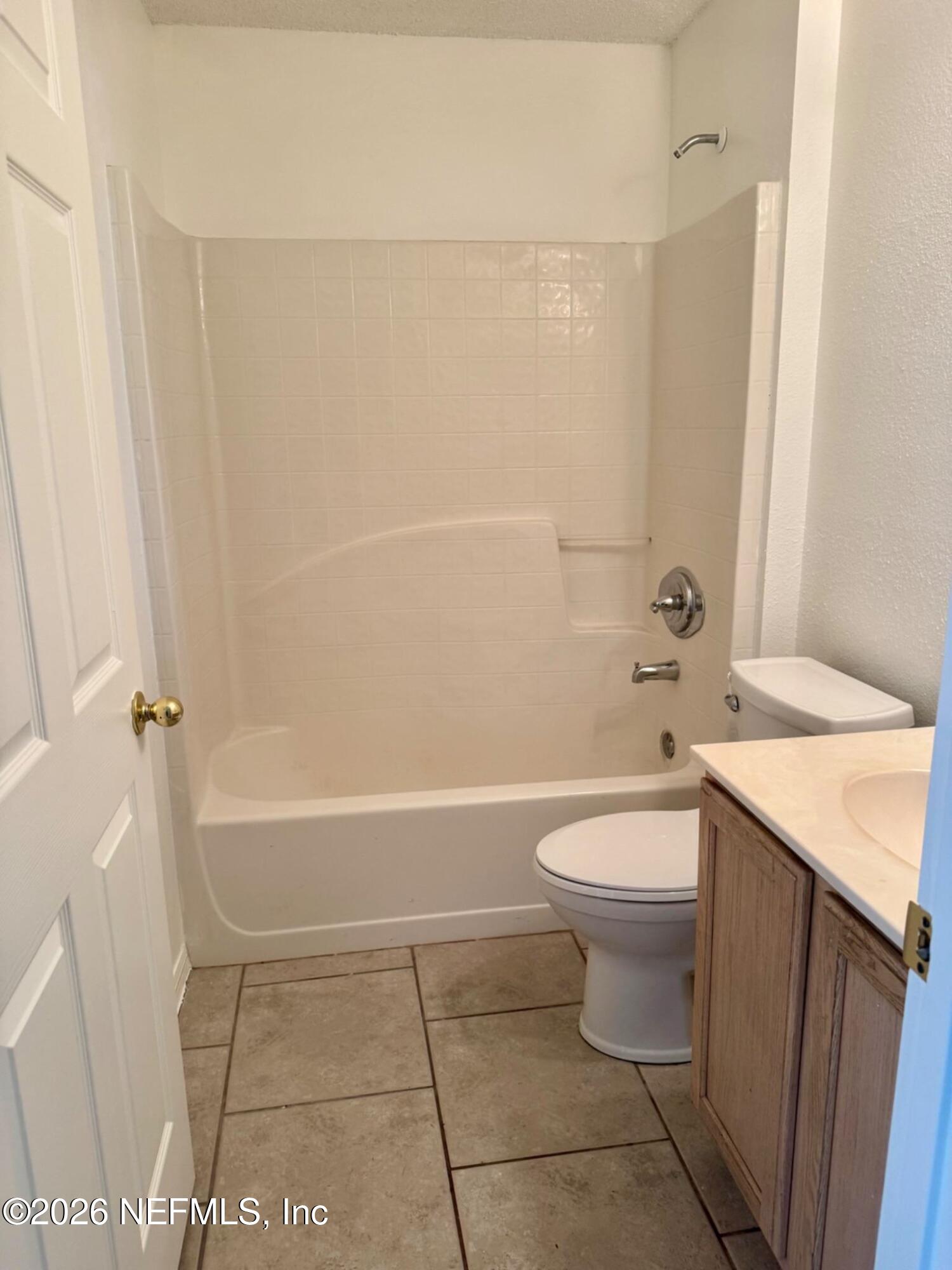 11447 Exmore Street Spring Hill, FL 34609 - Photo 27 of 31 a bathroom with a sink a toilet and shower