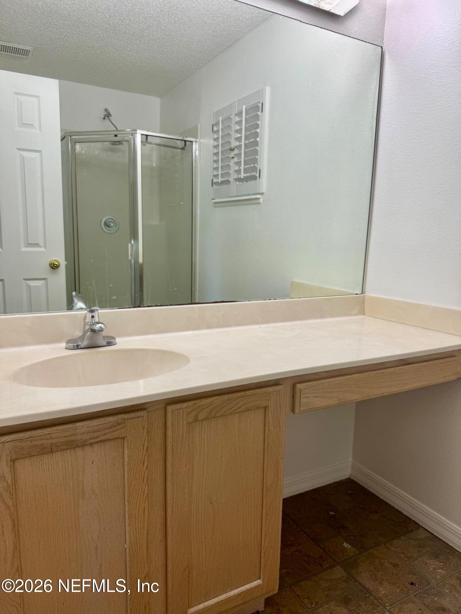11447 Exmore Street Spring Hill, FL 34609 - Photo 9 of 31 a bathroom with a sink and a mirror