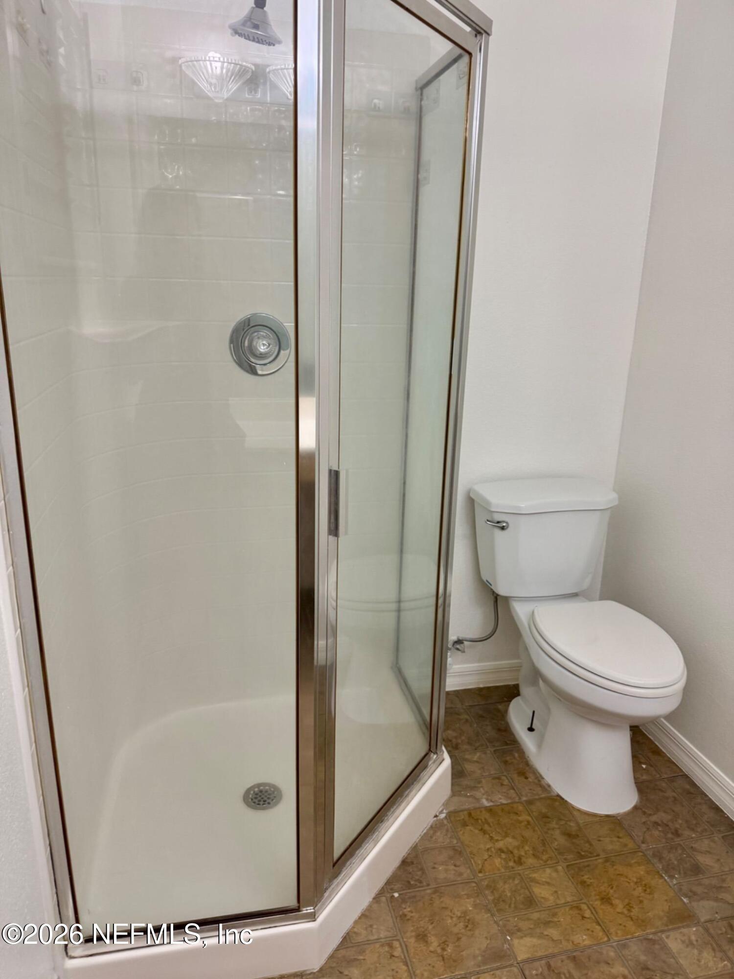 11447 Exmore Street Spring Hill, FL 34609 - Photo 10 of 31 a bathroom with a toilet and a shower