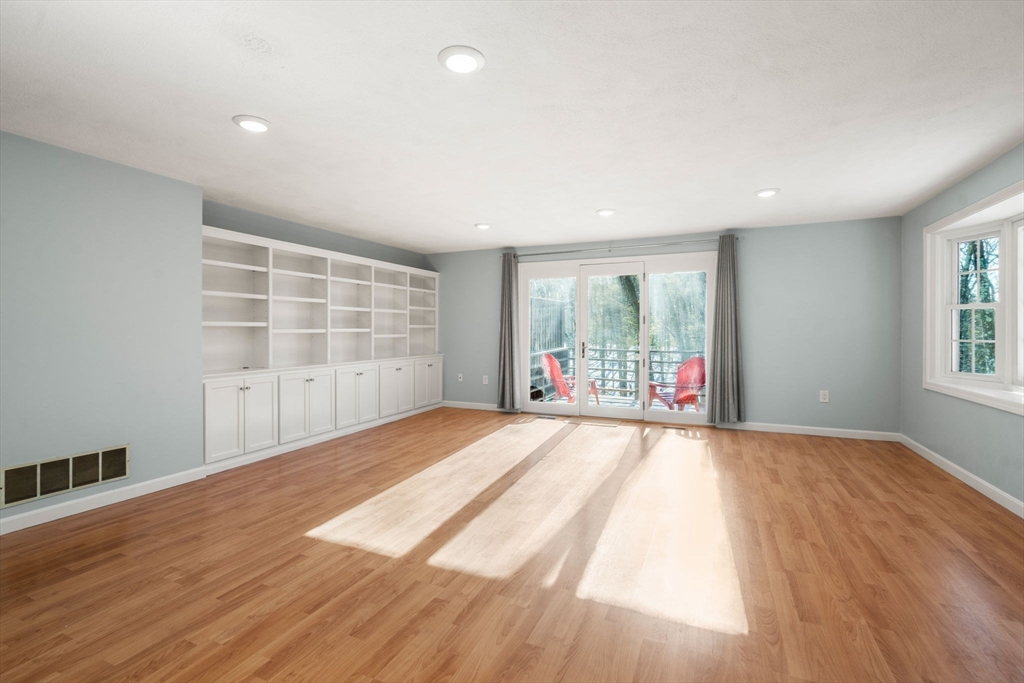 9 Oak Ridge Drive, Unit 6 Maynard, MA 01754 - Photo 16 of 39 a view of an empty room with wooden floor and a window