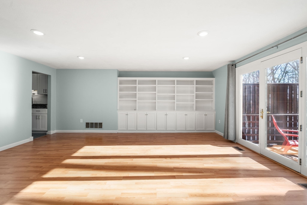 9 Oak Ridge Drive, Unit 6 Maynard, MA 01754 - Photo 18 of 39 a view of an empty room with wooden floor and a window